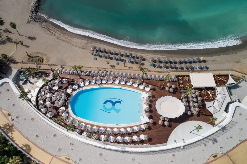Puerto Banus nightclub open-air terrace at night with marina lights