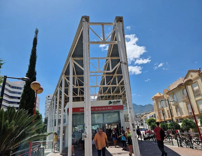 Cercanías C1 train arriving at Arroyo de la Miel-Benalmadena station platform on a sunny afternoon